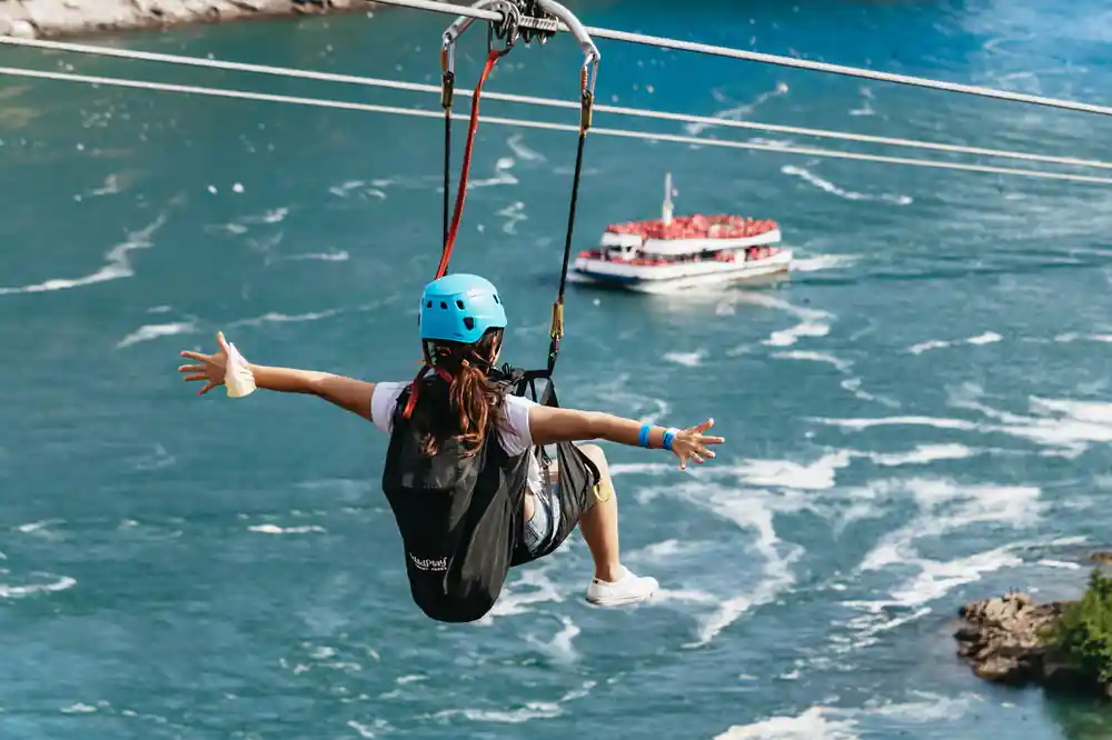 A rider above the river with a tour boat below