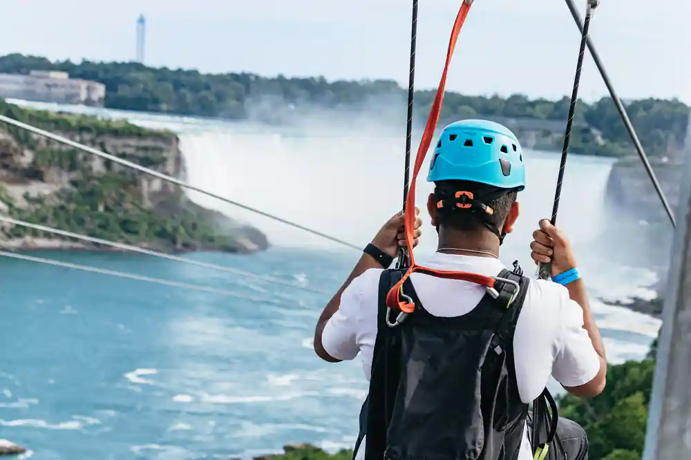 A rider seen from behind with the mist of the falls ahead