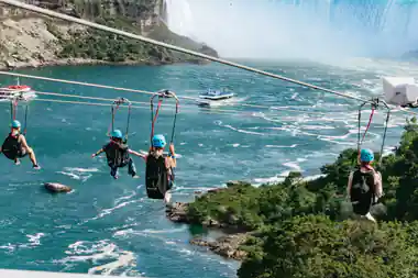 Two riders on parallel lines above the river with the falls behind